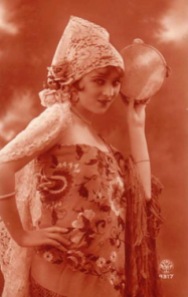 vintage photo of a woman dressed as a Gypsy with a tambourine